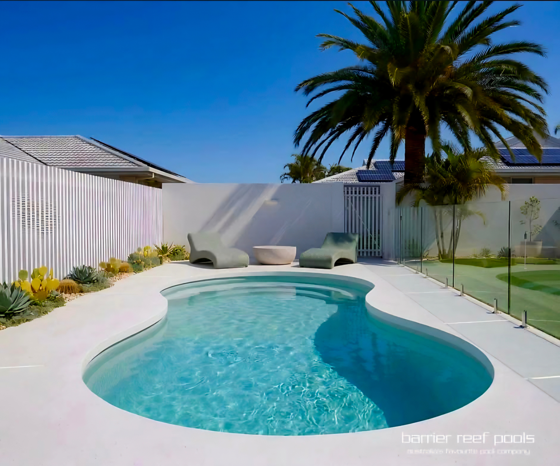 Freeform backyard pool cleaned and sparkling after regular pool servicing